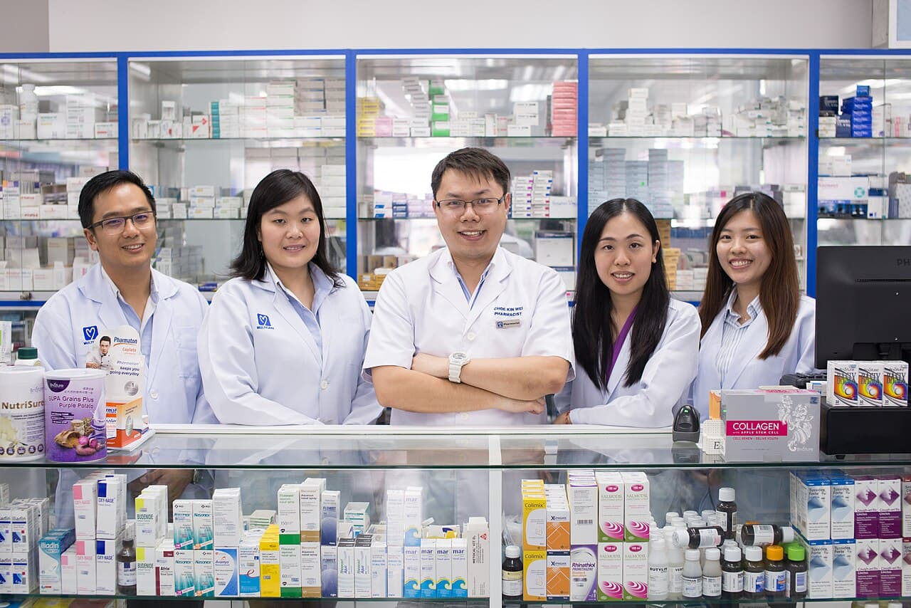 Pharmacy staff reviewing purchase orders and supplier invoices