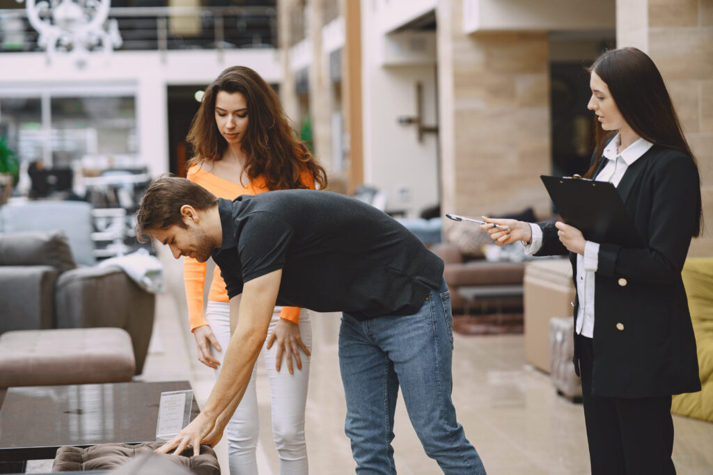 Couple with salesman in furniture store